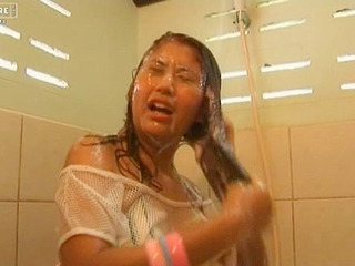 Japanese babe April Lim takes a horny shower with a giant dick while fantasizing about nippon porn.