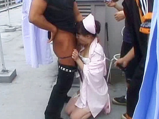 Wild nurse giving a hot Asian blowjob outdoors